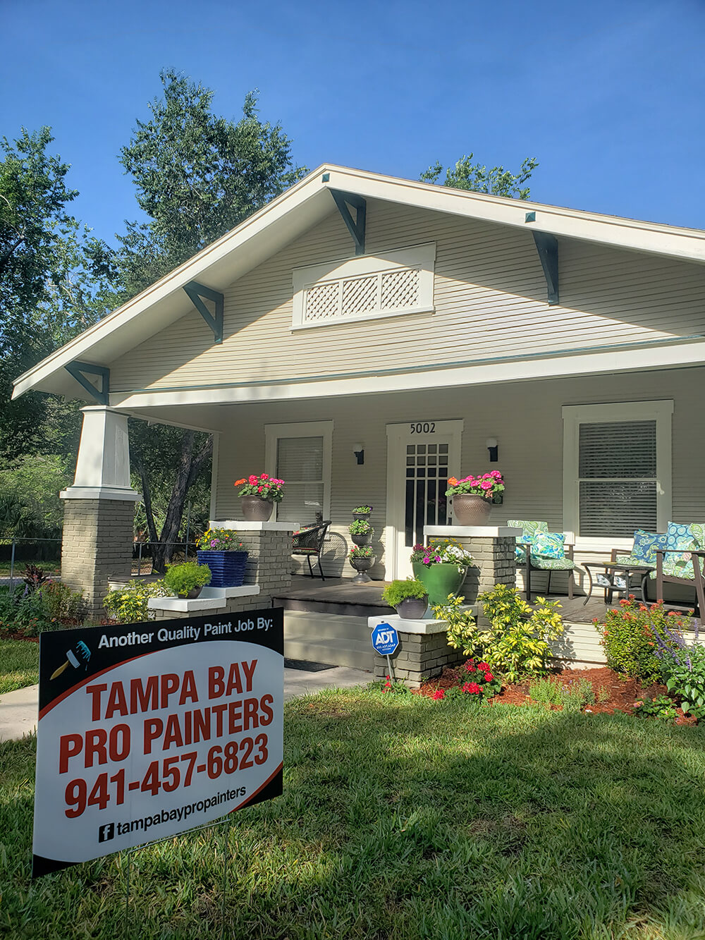 Charming Tampa Bay house painted by Tampa Bay Pro Painters with yard sign